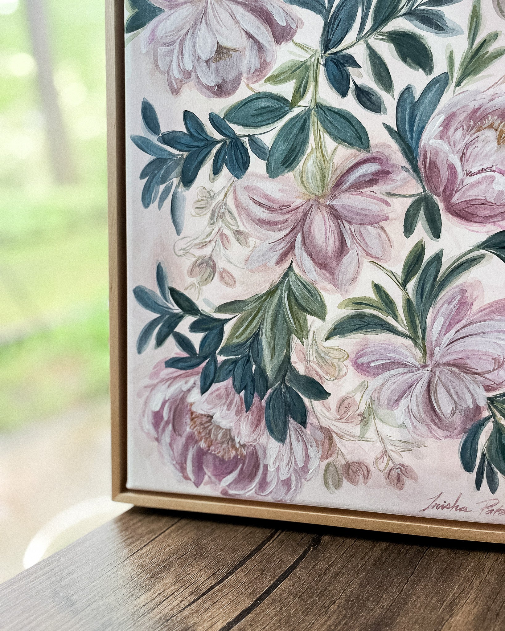 In Her Stillness botanical watercolor art by Trisha Patel displayed in simple maple floater frame, elegant floral wall décor honoring the quiet strength of women
