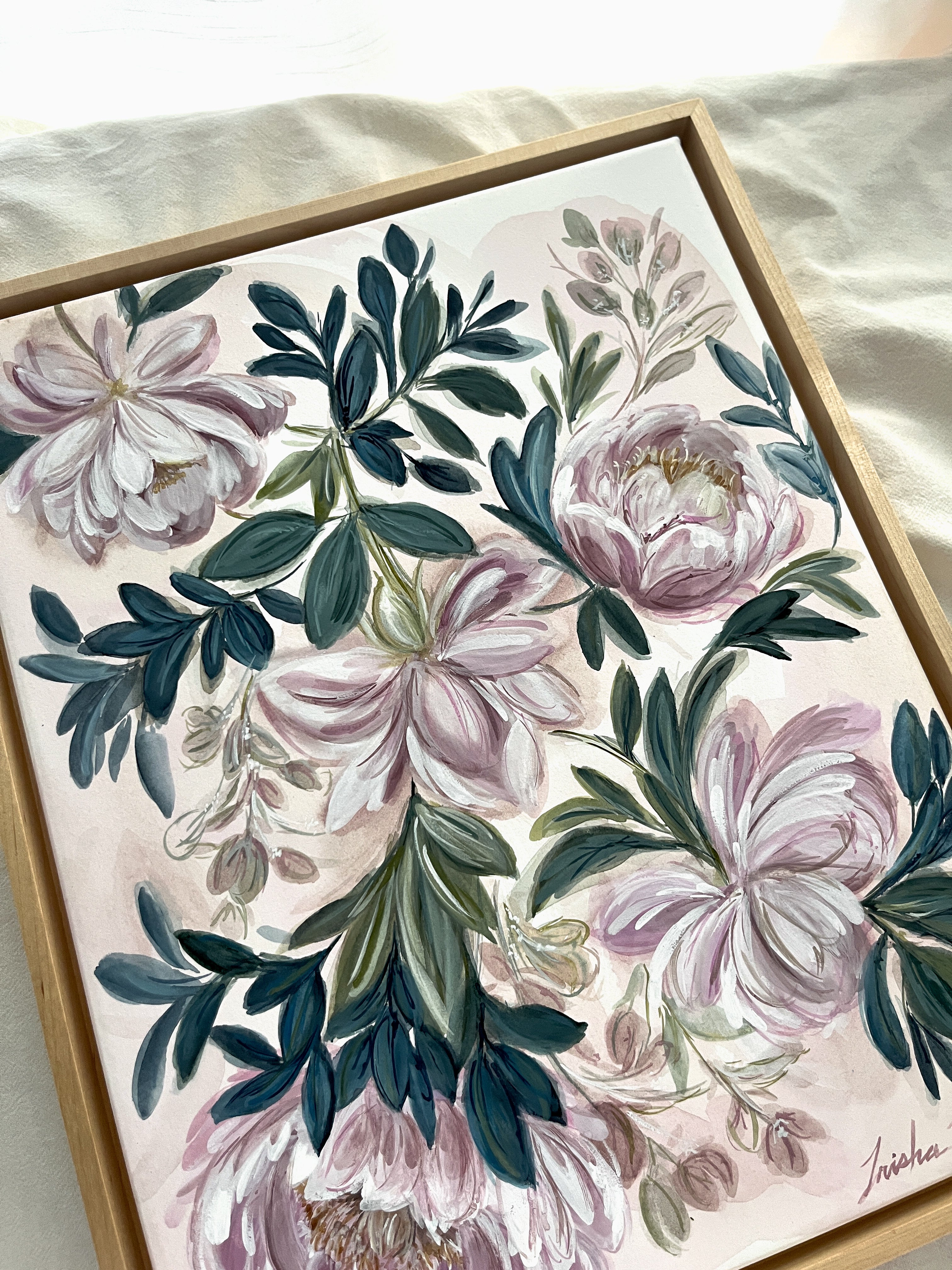 In Her Stillness by Trisha Patel, original watercolor painting featuring the rose and the peony symbolizing women’s love, grace, compassion, and unwavering strength, botanical art in simple maple floater frame