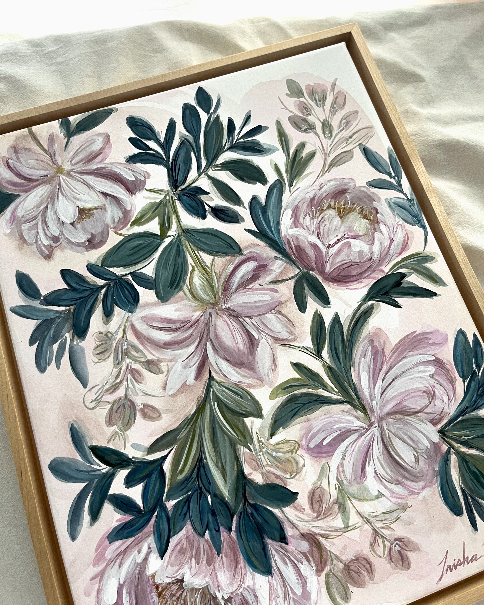 In Her Stillness botanical watercolor art by Trisha Patel displayed in simple maple floater frame, elegant floral wall décor honoring the quiet strength of women