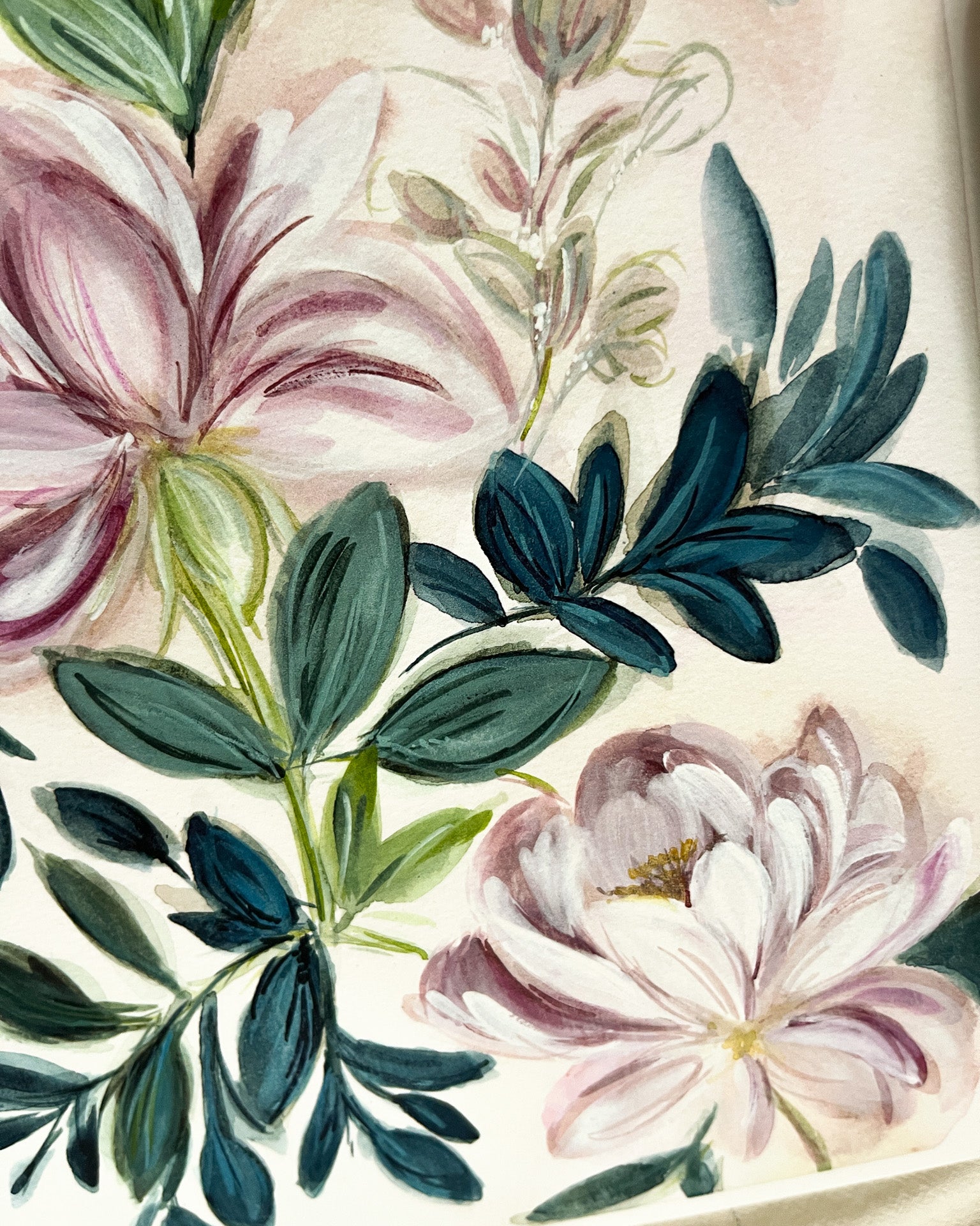 Close-up of floral design with pink and white flowers and green leaves on a beige background
