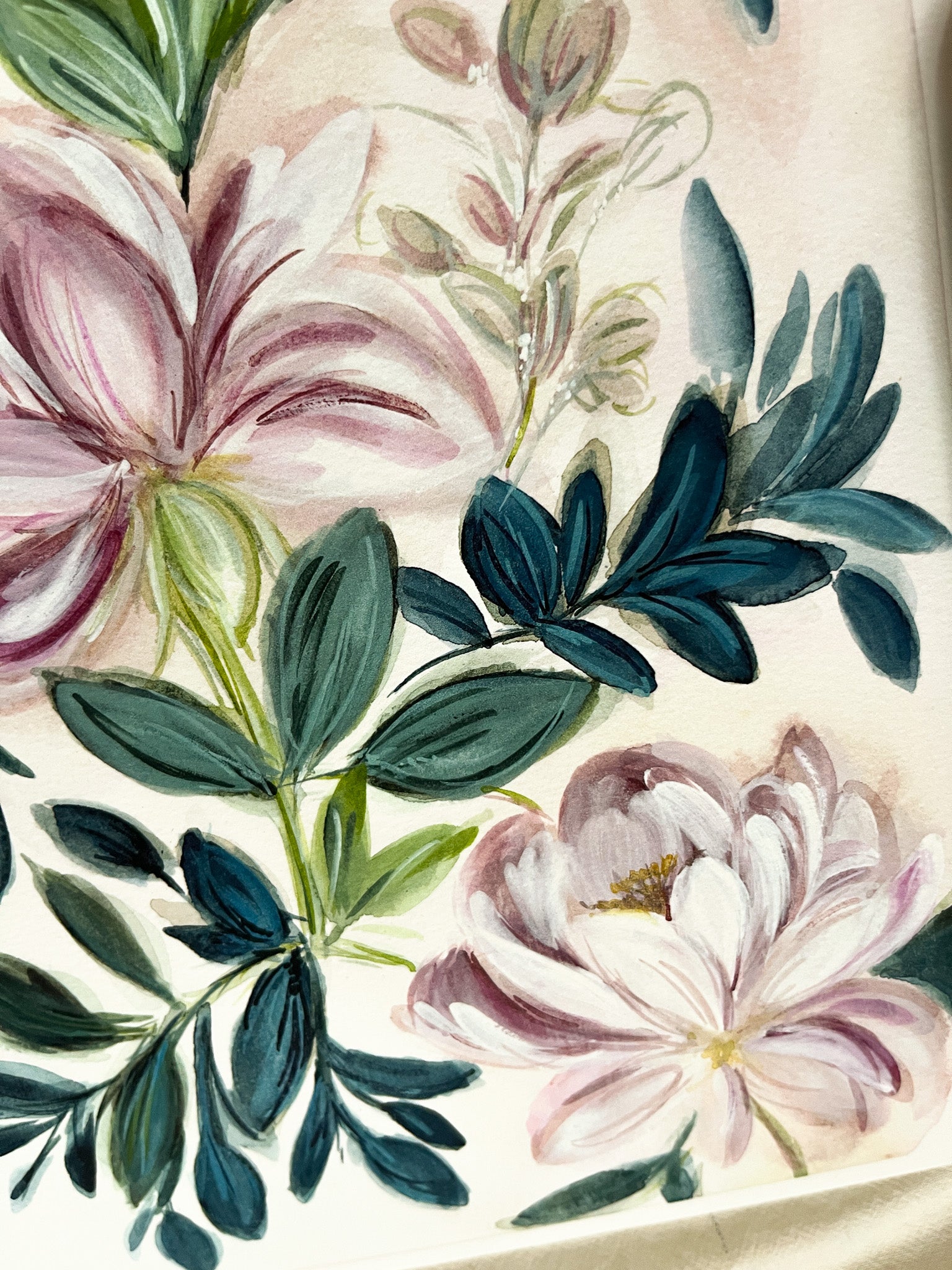 Close-up of floral design with pink and white flowers and green leaves on a beige background