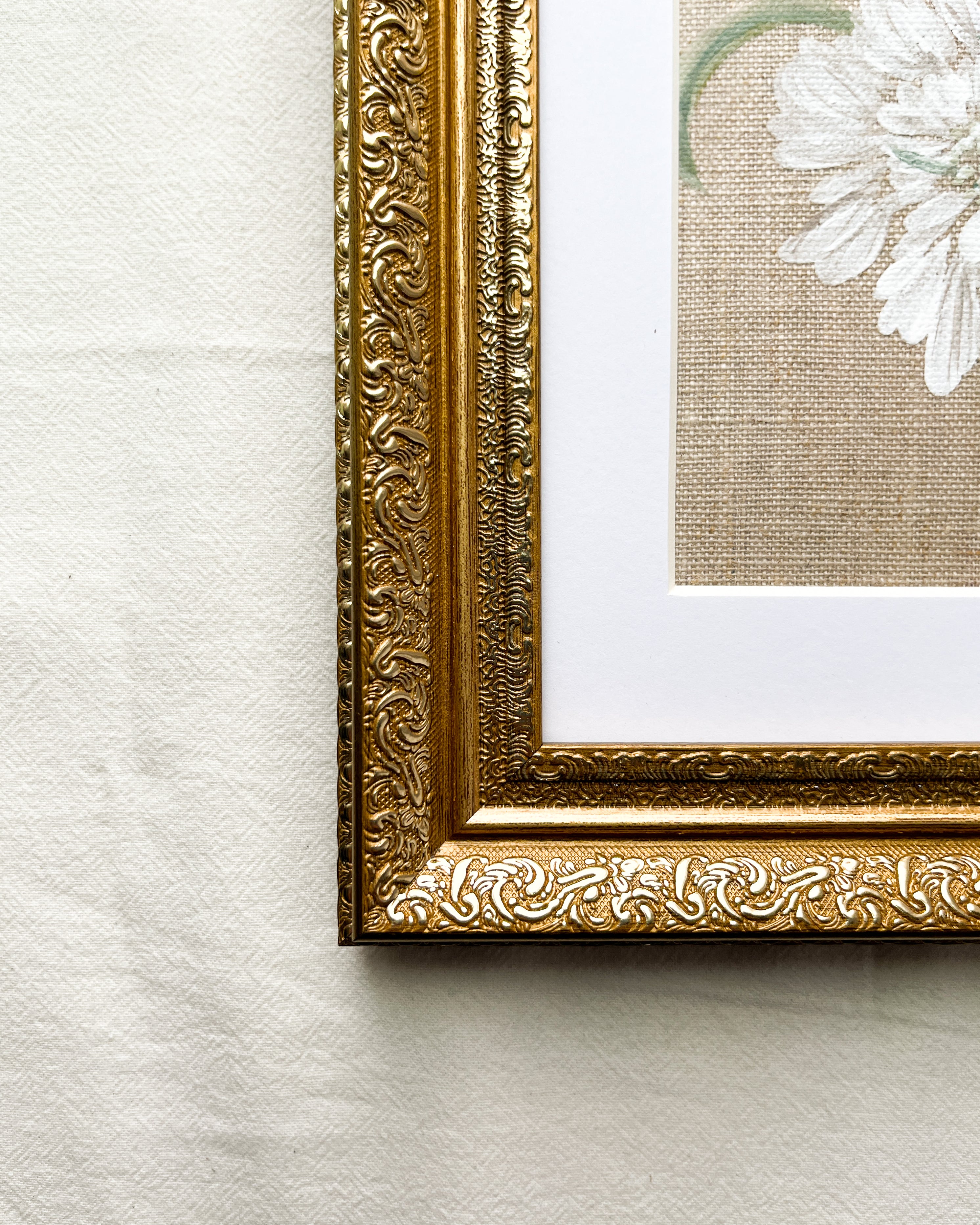 Close-up of ornate frame with elegant metallic finish on Reflective Bloom white scabiosa watercolor painting by Trisha Patel, botanical art wall décor