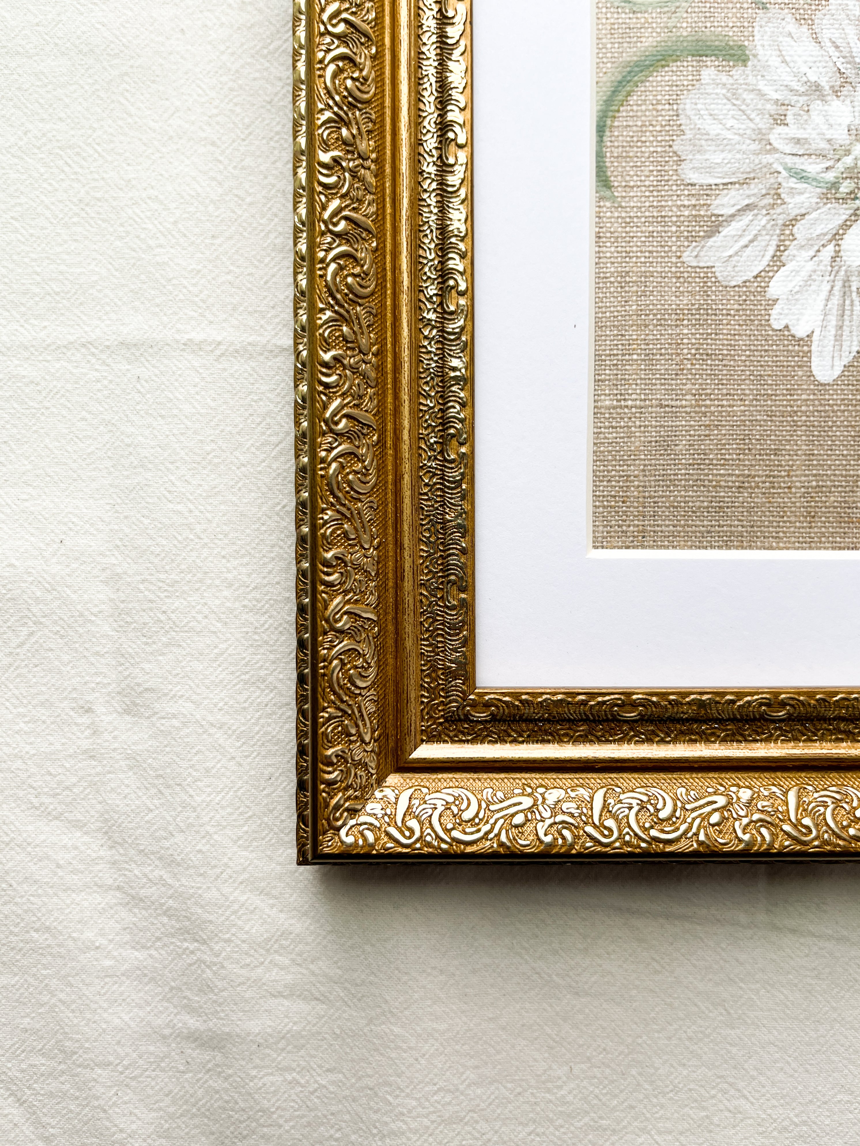 Close-up of ornate frame with elegant metallic finish on Reflective Bloom white scabiosa watercolor painting by Trisha Patel, botanical art wall décor