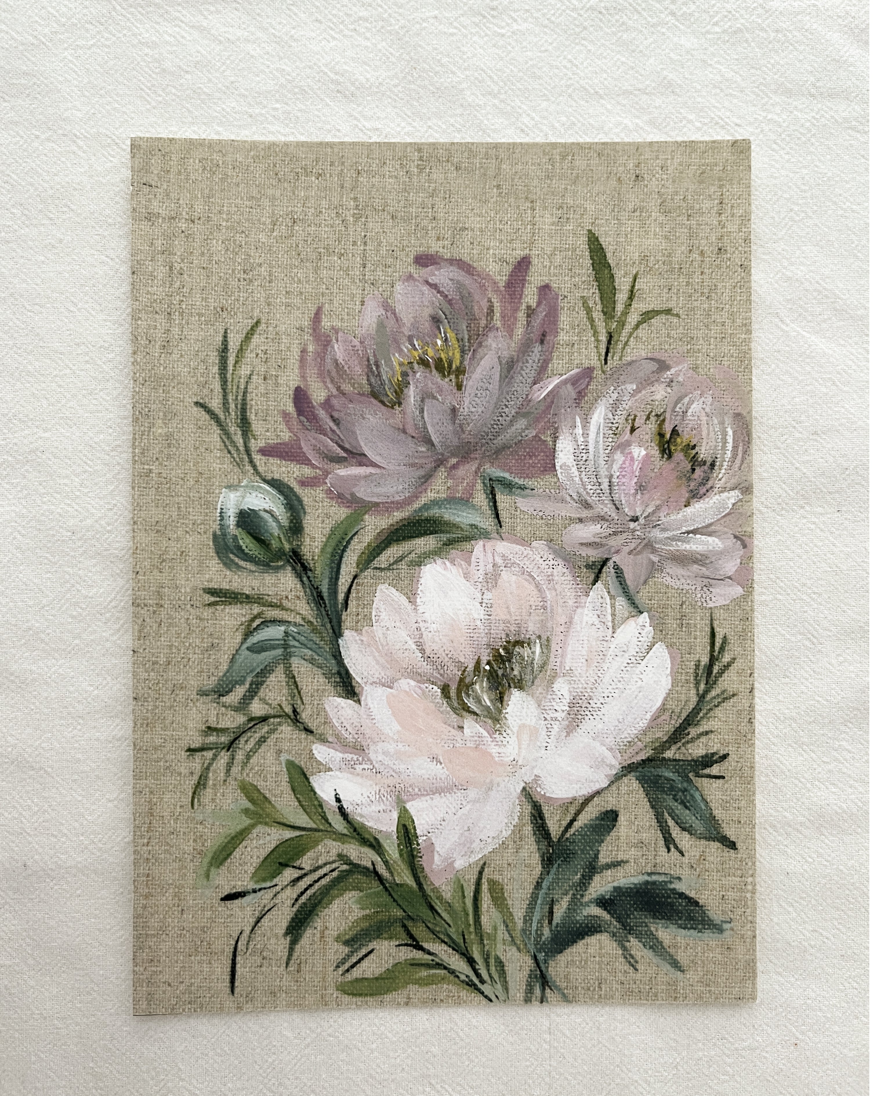 Shades of pink peony print displayed on brown background with decorative leaves