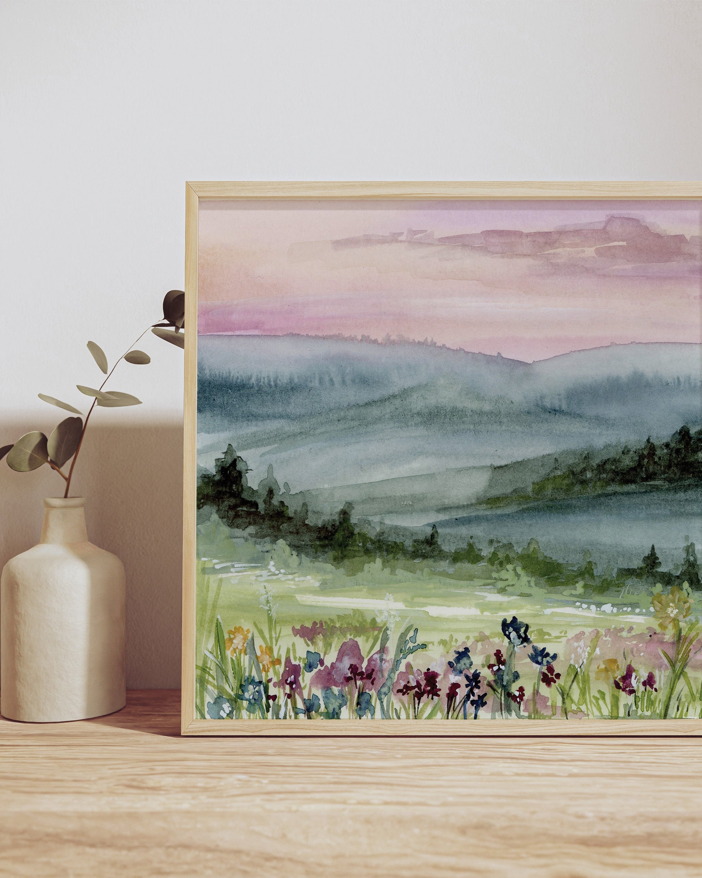 Whispering Dawn print displayed in elegant frame against neutral wall, showcasing serene pink and purple landscape