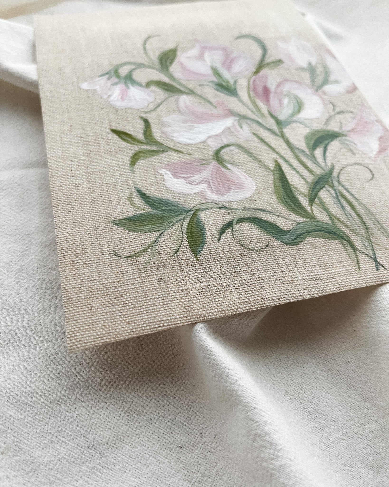 Close-up of sweet pea watercolor painting by artist Trisha Patel showing delicate petals and fine brushwork, symbolizing nurturing bonds and strength in transformative relationships.