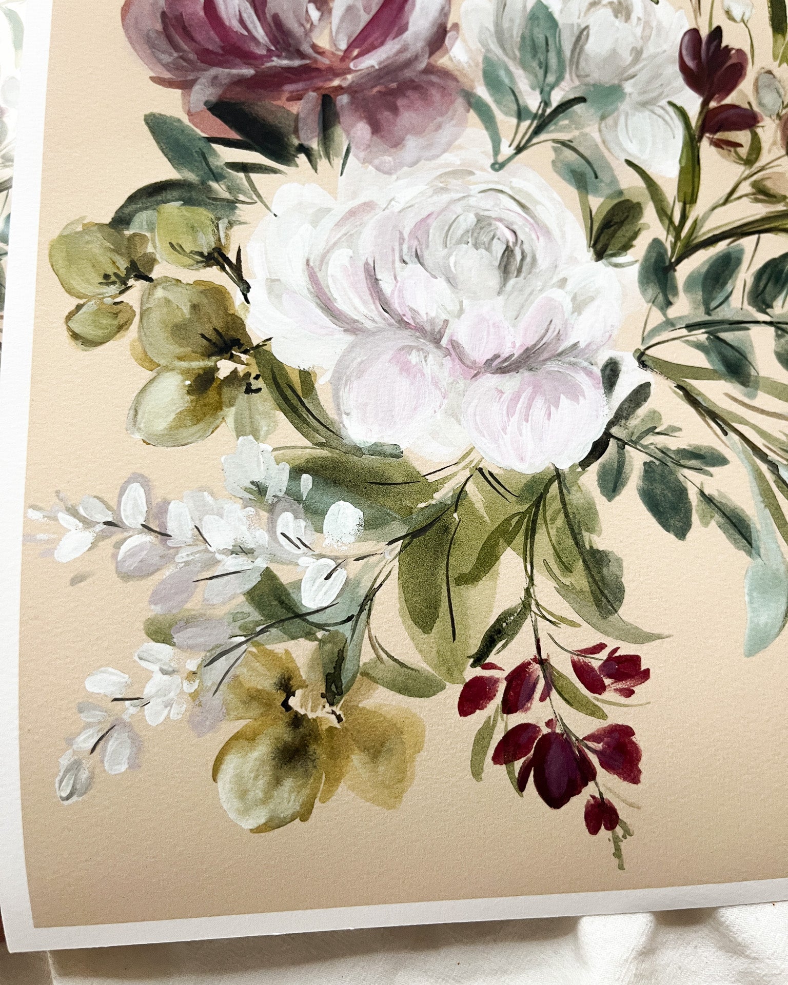 Floral arrangement with pink, white, and green flowers on a beige background