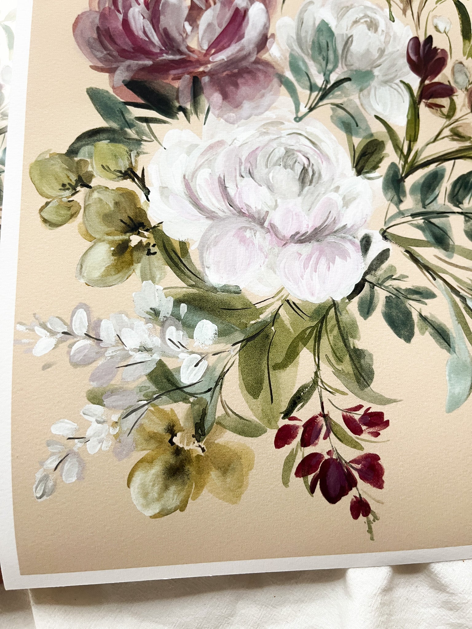 Floral arrangement with pink, white, and green flowers on a beige background