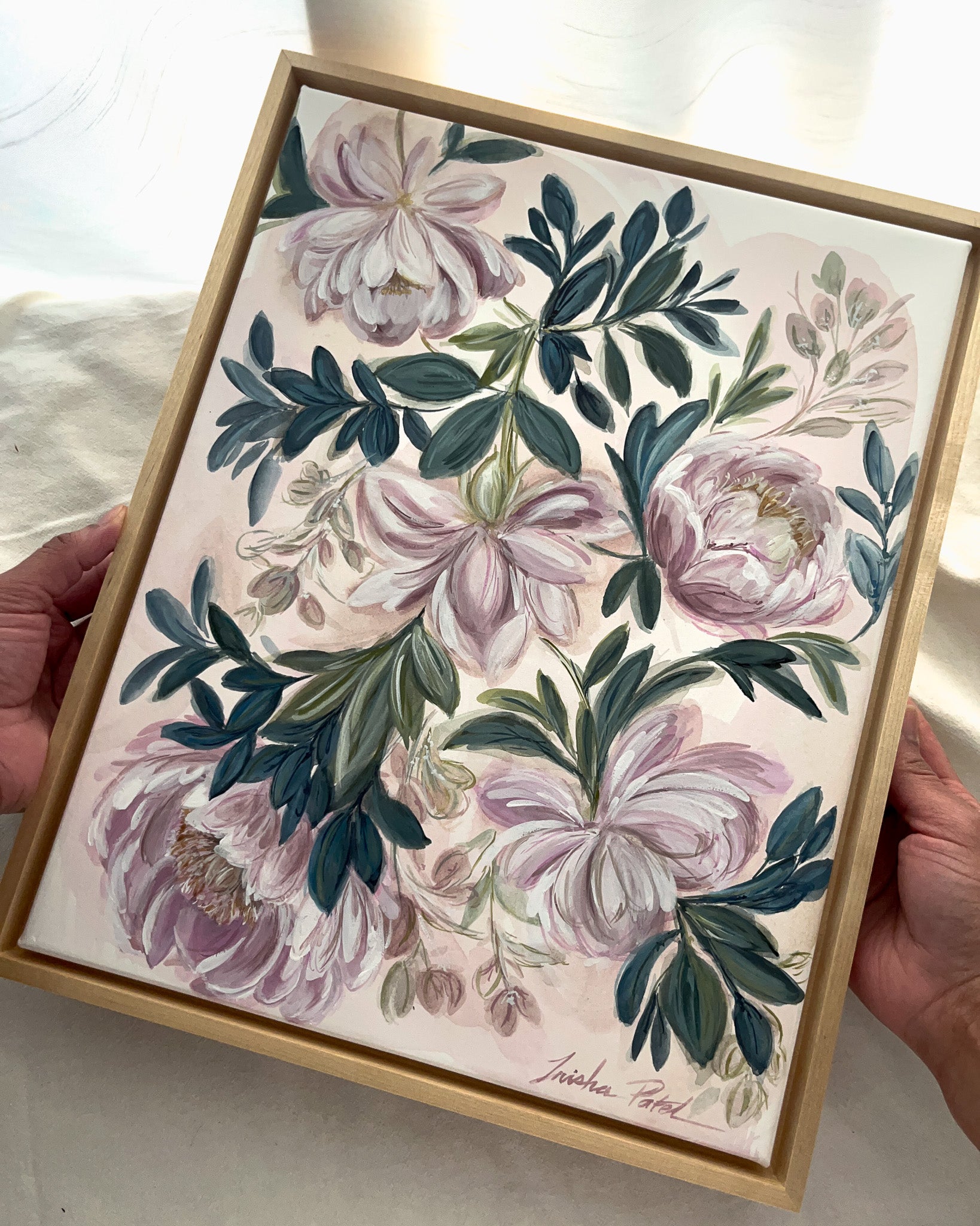 In Her Stillness botanical watercolor art by Trisha Patel displayed in simple maple floater frame, elegant floral wall décor honoring the quiet strength of women