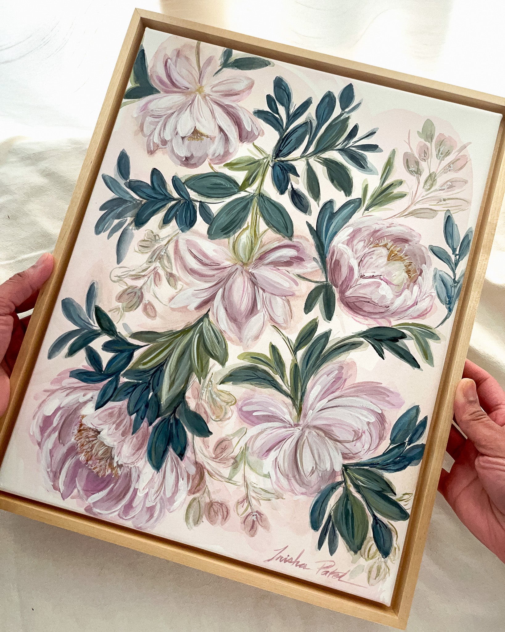 In Her Stillness botanical watercolor art by Trisha Patel displayed in simple maple floater frame, elegant floral wall décor honoring the quiet strength of women