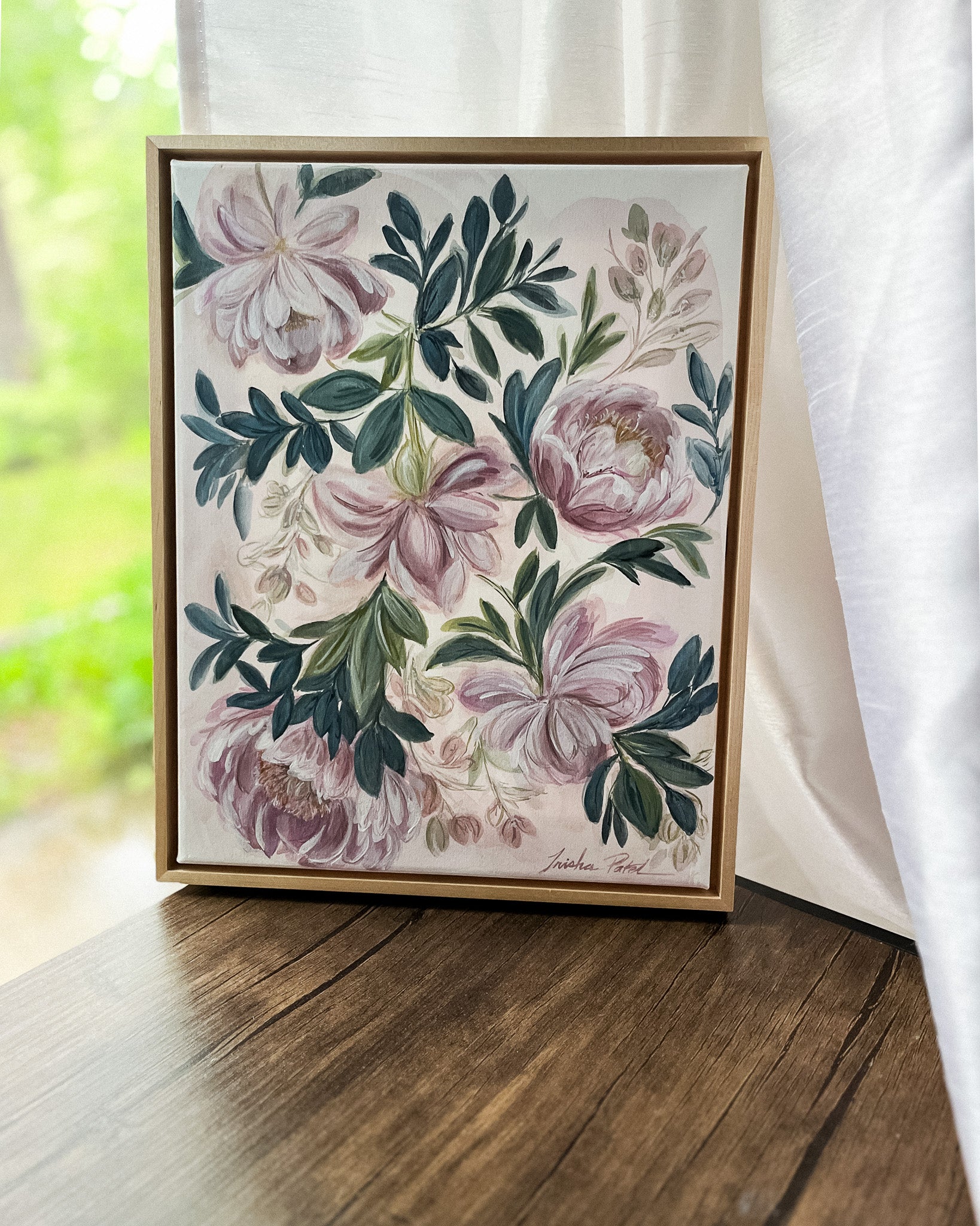 In Her Stillness by Trisha Patel, original watercolor painting featuring the rose and the peony symbolizing women’s love, grace, compassion, and unwavering strength, botanical art in simple maple floater frame