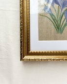 Detailed close-up of embossed floral and beaded pattern on gold-toned wooden frame of Springs Promise crocus watercolor painting by Trisha Patel