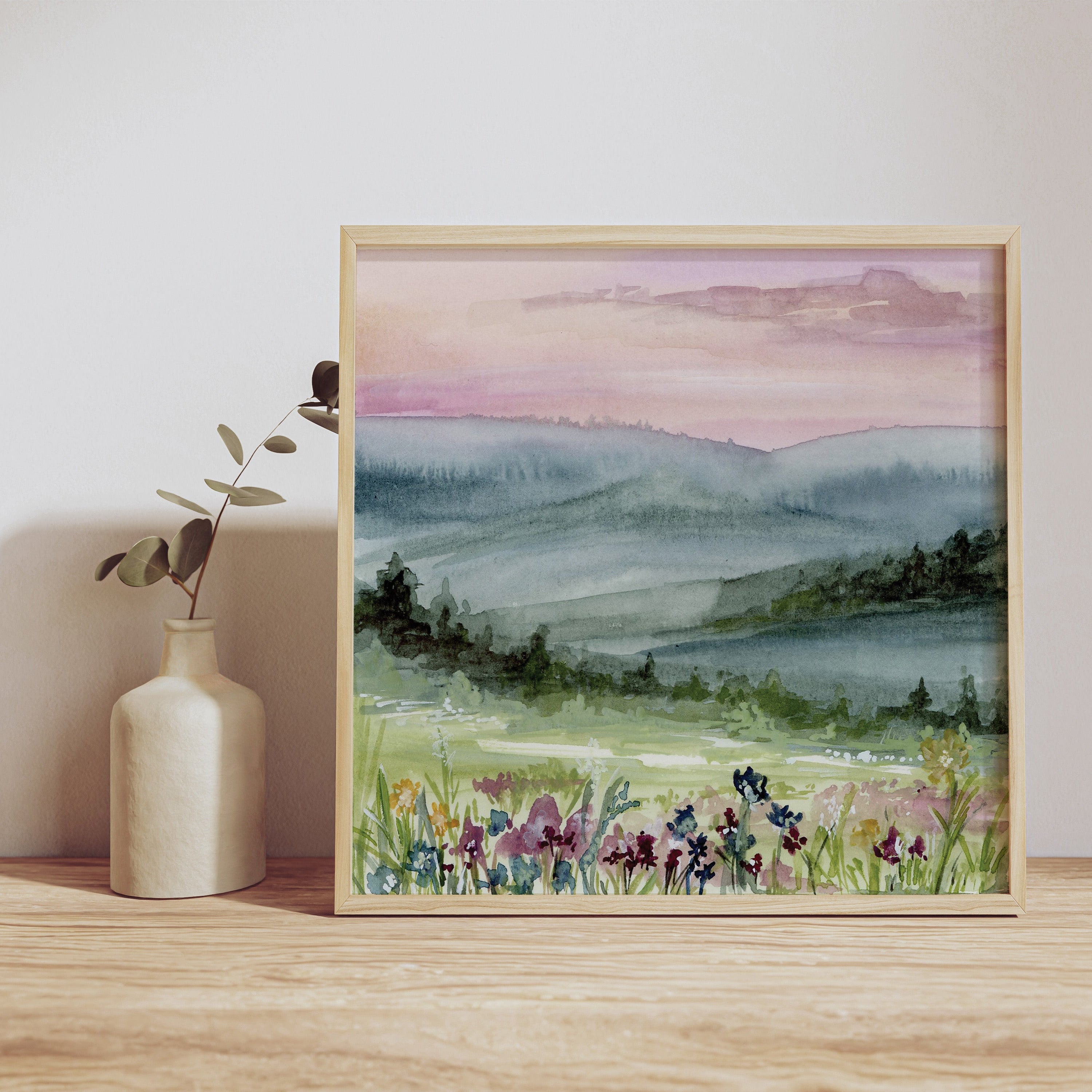 Whispering Dawn print displayed in elegant frame against neutral wall, showcasing serene pink and purple landscape
