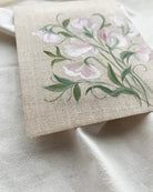 Close-up of sweet pea watercolor painting by artist Trisha Patel showing delicate petals and fine brushwork, symbolizing nurturing bonds and strength in transformative relationships.